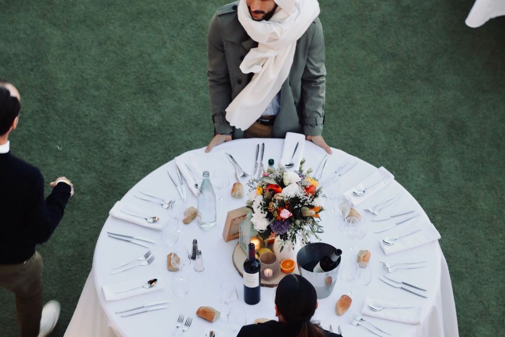 Table ronde dressée et fleurie, vue d'en haut, avant le dîner