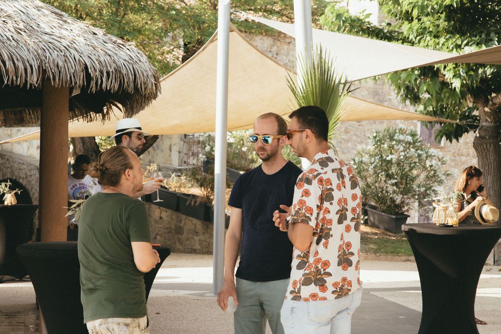 Apéritif à l'ombre des voiles et des paillotes, dans le jardin d'un domaine
