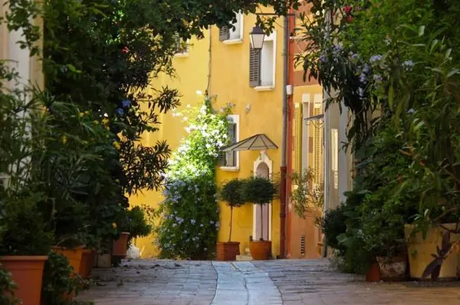 Une ruelle fleurie de Cassis montant entre deux façades colorées