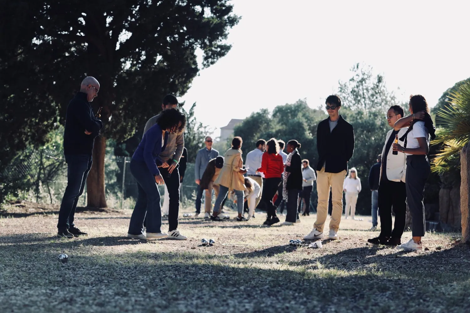 Tournoi de pétanque d'entreprise sur un terrain ombragé, en Provence